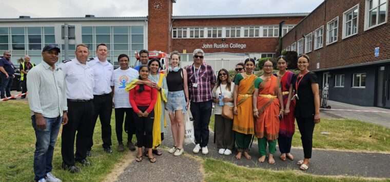 Group of picnic attendees posing for a photo outside the school entrance
