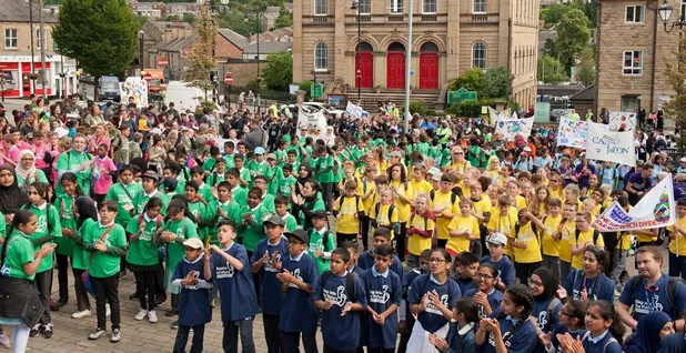 Hundreds of school chidren wearing brightly coloured t-shirts gathered in Batley town centre
