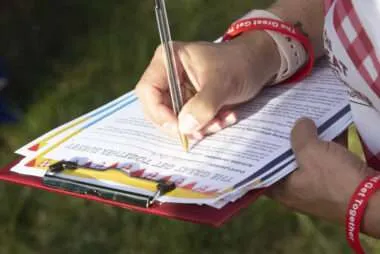 Photo of someone holding a pen and completing a Great Get Together survey