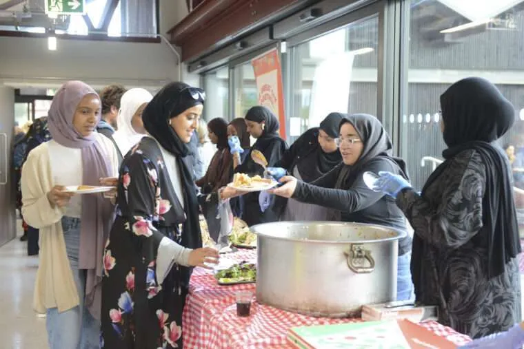 Young people serving food at the Grangetown Great Get Together in Cardiff, June 2022