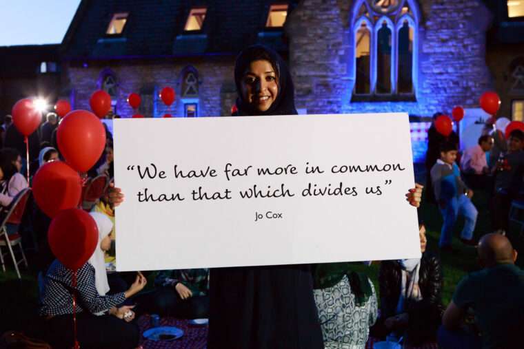 Photo of someone holding a placard that says Jo's more in common quote.