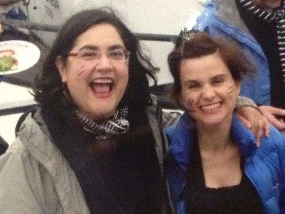 Photograph of Nisha Jani and Jo Cox. Nisha has her arm around Jo. They are both looking towards the camera and smiling broadly.